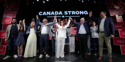 A polling station entrance in an urban Canadian riding on election day, with voters arriving to cast ballots as federal byelection results report Liberal wins in two Toronto-area ridings, strengthening the government’s majority in the House of Commons.
