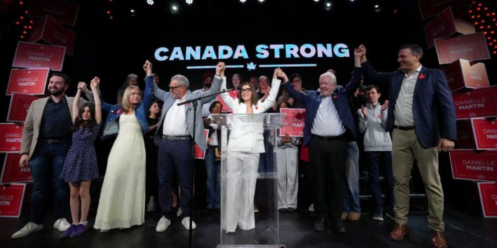 A polling station entrance in an urban Canadian riding on election day, with voters arriving to cast ballots as federal byelection results report Liberal wins in two Toronto-area ridings, strengthening the government’s majority in the House of Commons.