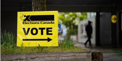 A person enters a polling station in Vancouver East riding during federal election day, walking toward the entrance of a community voting location on April 28, 2025.