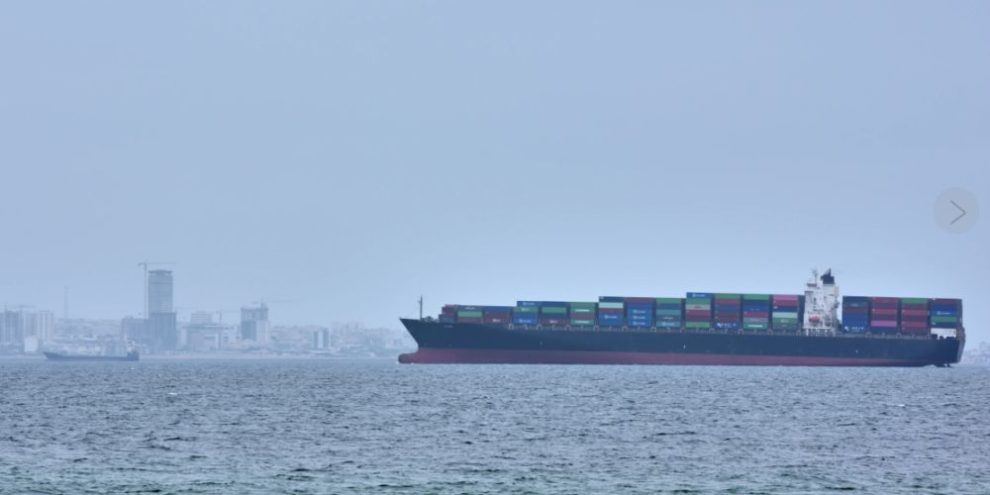 Container ship sailing through the Strait of Hormuz near Qeshm Island as tensions rise following Iranian military action and U.S. blockade