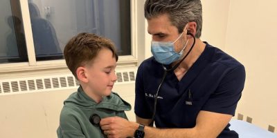 A doctor treats a young patient inside the emergency department at Stevenson Memorial Hospital in Alliston, Ontario.