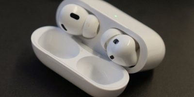 A pair of Apple AirPods Pro 2 displayed at an audiology clinic, representing wireless earbuds with built-in hearing aid capabilities under consideration in Ontario.