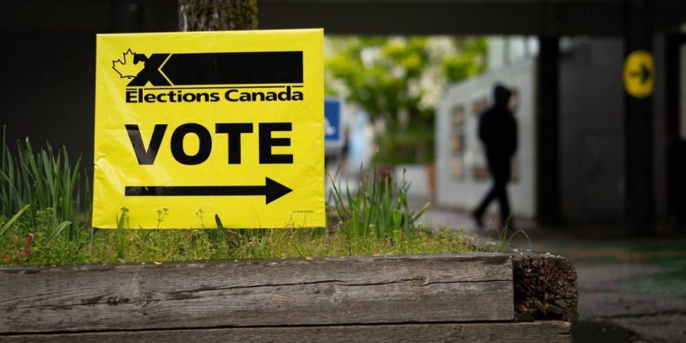 File photo -- A vote sign is posted as a person enters a polling station in the Vancouver East riding on federal election day in Vancouver., on Monday, April 28, 2025. THE CANADIAN PRESS/Ethan Cairns