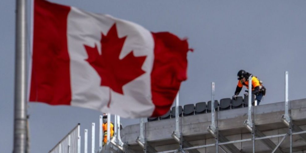 Workers assemble temporary seating high above the ground at BMO Field in Toronto ahead of the 2026 FIFA World Cup.