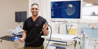 Dr. Ali Malik, respirologist and interventional pulmonologist at Royal Victoria Regional Health Centre, standing with the hospital’s Endobronchial Ultrasound (EBUS) system used for minimally invasive lung testing.