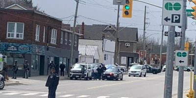 Barrie police lead a handcuffed man away following a tactical response at a home on Essa Road on April 19, 2026.