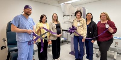 Hospital staff and leaders stand beside a newly installed mammography machine at Orillia Soldiers’ Memorial Hospital during an unveiling event.