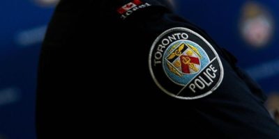 Toronto police officer uniform during press conference on cybercrime investigation involving seized SMS blaster devices