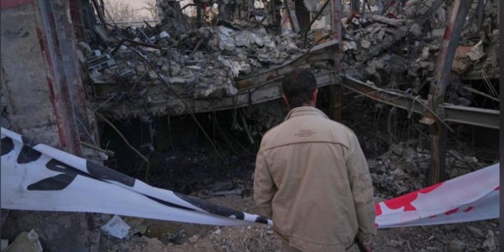 A man surveys damage at the Grand Hosseiniyeh complex in Zanjan, Iran, after reported U.S.-Israeli airstrikes.