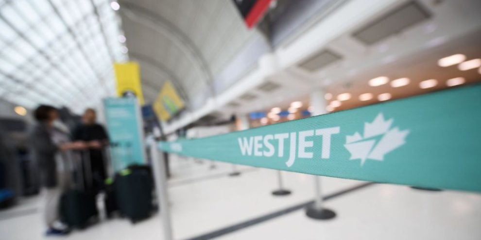 WestJet check-in counters at Toronto Pearson International Airport as the airline announces a surcharge and flight reductions due to rising fuel costs.