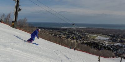 Skier descending a slope at Blue Mountain Resort during late-season conditions