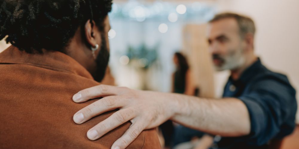 Man supporting friend