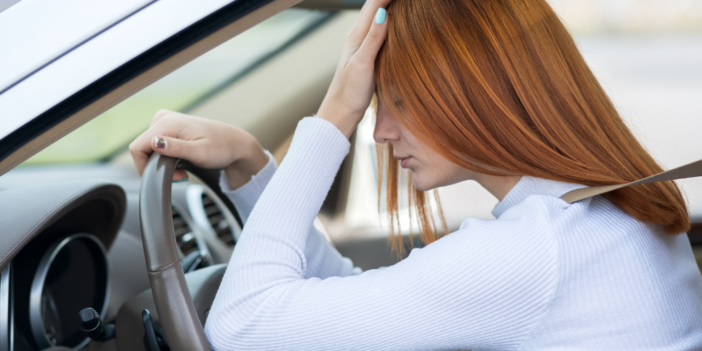 Woman stressed in car thing about mental health