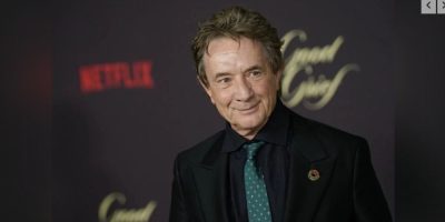 Martin Short poses on the red carpet at the premiere of a Netflix film event at the Egyptian Theatre in Los Angeles, smiling for cameras.