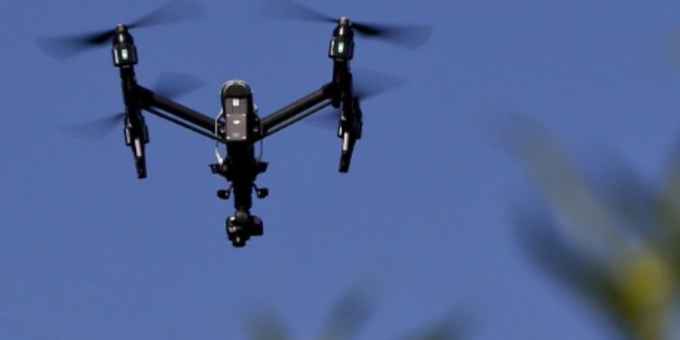 A drone equipped with a thermal camera flying over a field, representing Ontario’s decision to ban Chinese-made drones for government and police use.