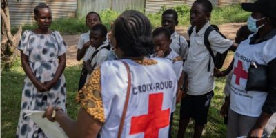 A Red Cross volunteer conducts a house-to-house awareness campaign in Bunia during the Ebola outbreak, as Canada announces stricter travel and immigration measures for travellers from Democratic Republic of the Congo, Uganda, and South Sudan.