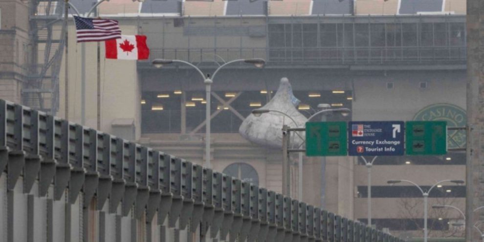 American and Canadian flags at the Rainbow Bridge border crossing between the U.S. and Canada in Niagara Falls, New York.