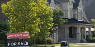 Real estate sign displayed outside homes in Vaughan, Ontario, amid rising housing affordability concerns for younger Canadians.