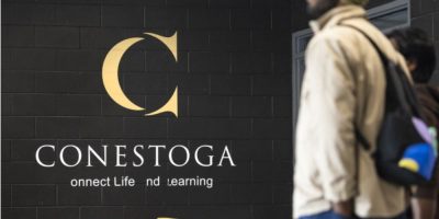 Students walking on the Conestoga College campus in Kitchener, Ontario on a spring day.