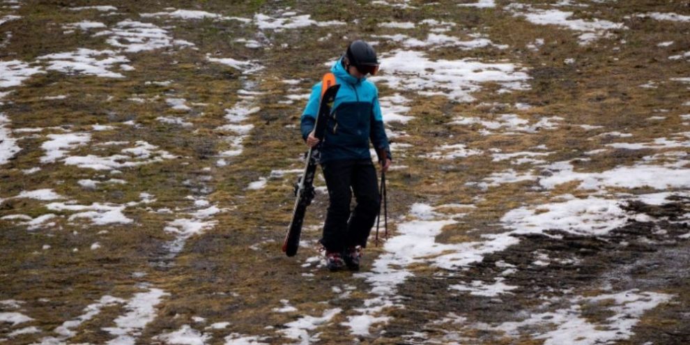 A skier walks down a patchy ski slope at Whistler, B.C., during an unusually warm winter linked to El Niño conditions.