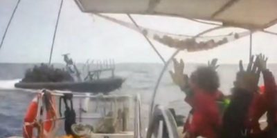 CCTV footage shows activists aboard a flotilla vessel with their hands raised as an approaching naval boat nears during the interception of the Global Sumud Flotilla in international waters.