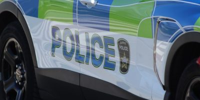 Barrie Police logo displayed on a cruiser parked outside the Barrie Simcoe Emergency Services Campus in Barrie, Ontario.