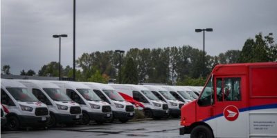 Canada Post delivery vehicles parked at a depot in Burnaby, British Columbia, as postal workers approve a new five-year collective agreement ending a lengthy labour dispute.