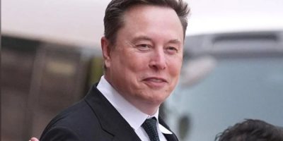 Elon Musk arrives at a welcoming ceremony in Beijing on May 14, 2026, after SpaceX's blockbuster Wall Street debut made him the world's first trillionaire.