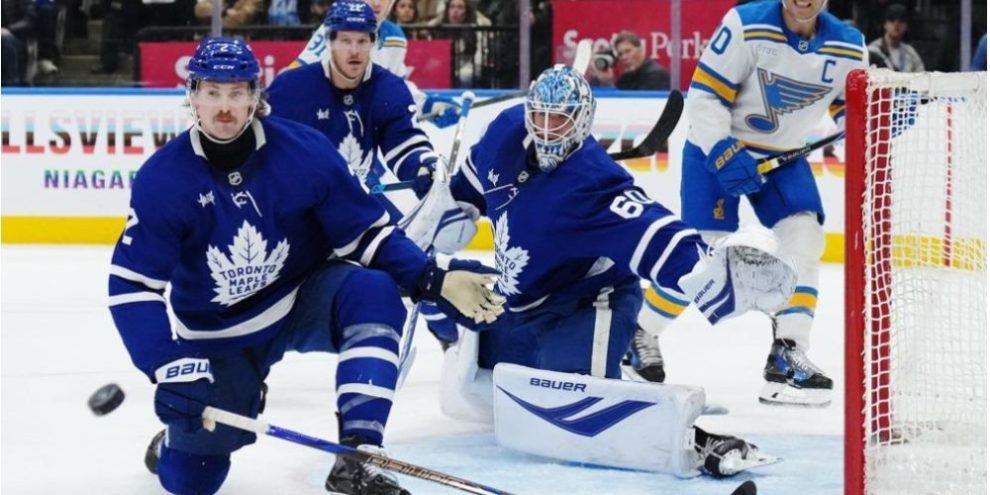 Toronto Maple Leafs goaltender Joseph Woll and defenceman Simon Benoit in action during an NHL game against the St. Louis Blues at Scotiabank Arena in Toronto.