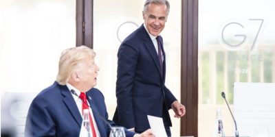 Prime Minister Mark Carney and U.S. President Donald Trump speak during a G7 working luncheon in Évian-les-Bains, France, during the 2026 summit.