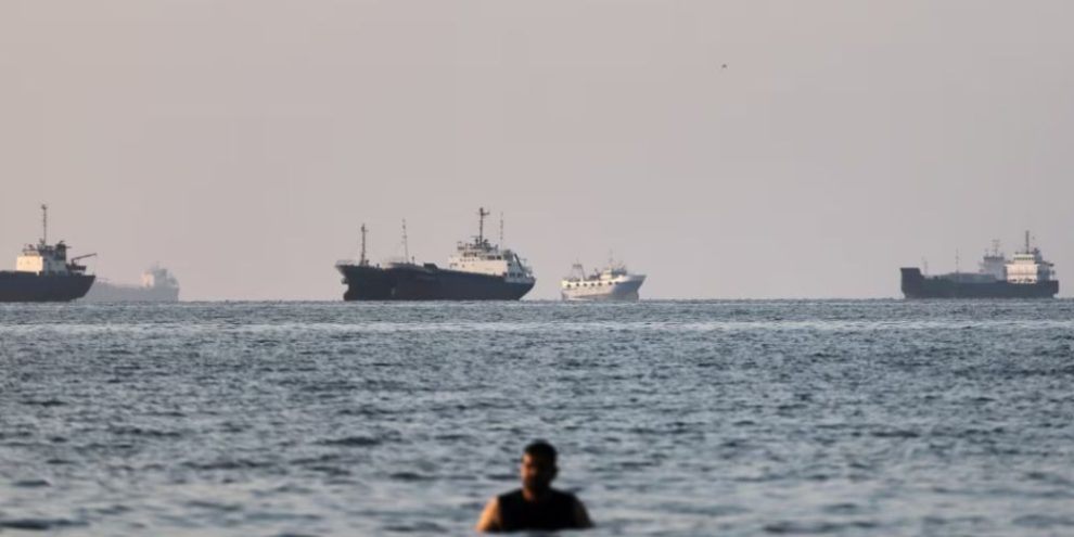 Cargo and commercial vessels anchored in the Strait of Hormuz off Bandar Abbas, Iran, after the U.S. and Iran reached an agreement to reopen the strategic waterway and resume nuclear negotiations.