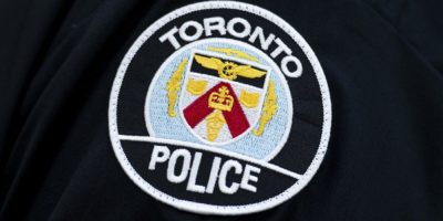 A Toronto Police Service logo displayed on a police vehicle. Investigators have arrested a second suspect in the March shooting at the U.S. consulate in Toronto as part of a broader gun-for-hire investigation across the Greater Toronto Area.