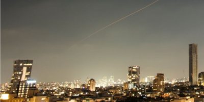 A projectile streaks through the sky over central Israel during an Iranian missile attack, Sunday, June 7, 2026