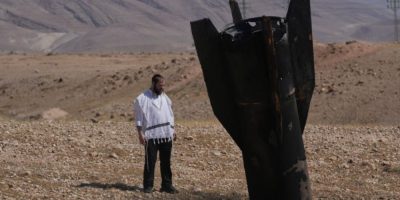 A man stands beside the wreckage of an Iranian missile that landed near Jericho in the West Bank on June 8, 2026, amid renewed fighting between Israel and Iran.
