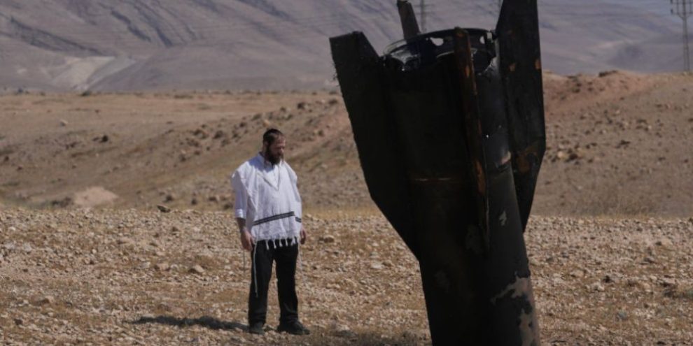 A man stands beside the wreckage of an Iranian missile that landed near Jericho in the West Bank on June 8, 2026, amid renewed fighting between Israel and Iran.