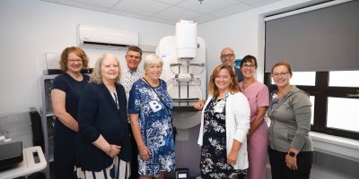 Group photo at mammography expansion event at Collingwood General and Marine Hospital showing hospital leadership, foundation representatives, donors, and diagnostic imaging staff standing together in front of celebratory signage.