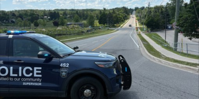 Barrie Police cruiser blocks Little Avenue during the investigation into an e-scooter collision that seriously injured a 15-year-old rider.