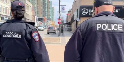 Barrie Police officer and Special Constable patrol downtown Barrie in uniform during a foot patro