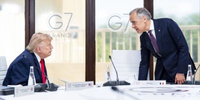 Prime Minister Mark Carney speaks with U.S. President Donald Trump during a G7 leaders’ meeting in France in June 2026.