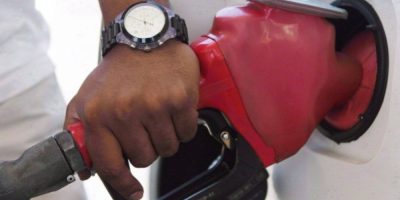 A person pumps gasoline into a vehicle at a Toronto gas station.