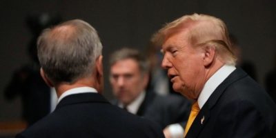 Prime Minister Mark Carney and U.S. President Donald Trump speak during a NATO summit roundtable in Turkey.