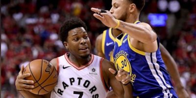 Toronto Raptors guard Kyle Lowry drives to the basket as Golden State Warriors guard Stephen Curry defends during Game 2 of the 2019 NBA Finals in Toronto.