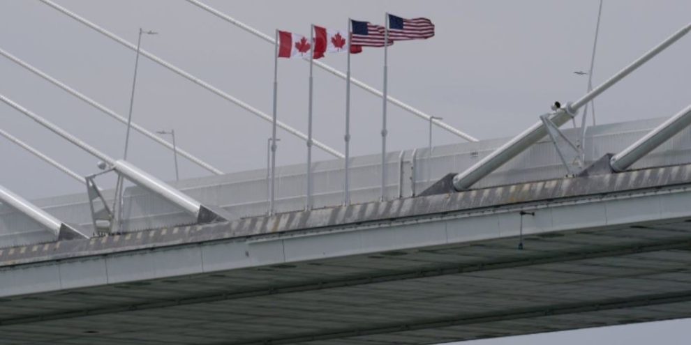 Canadian and American flags hang on the Gordie Howe International Bridge spanning the Detroit River between Windsor, Ontario, and Detroit, Michigan, in May 2026. File photo.