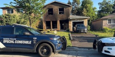 Barrie police secure the scene outside a fire-damaged home on Charlbrook Avenue in Barrie's north end as the Ontario Fire Marshal investigates the overnight blaze.