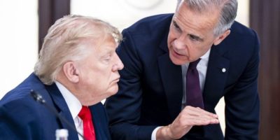 Mark Carney and Donald Trump speak during a working luncheon at the G7 summit in France