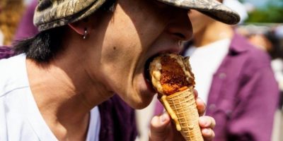 Person bites into a Carnival Cone from Beach Hill Smokehouse at the CNE in Toronto