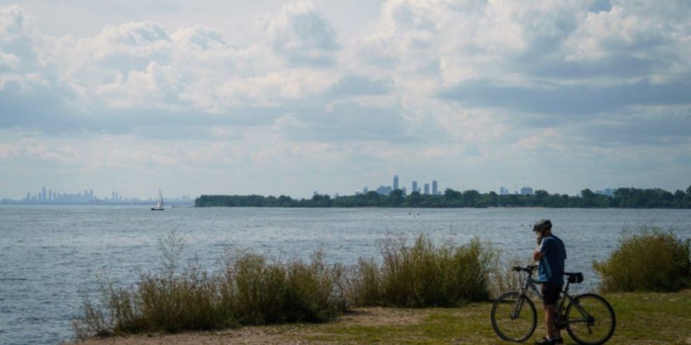 Cyclist looks out at Lake Ontario from Tommy Thompson Park in Toronto on Aug. 25, 2026.