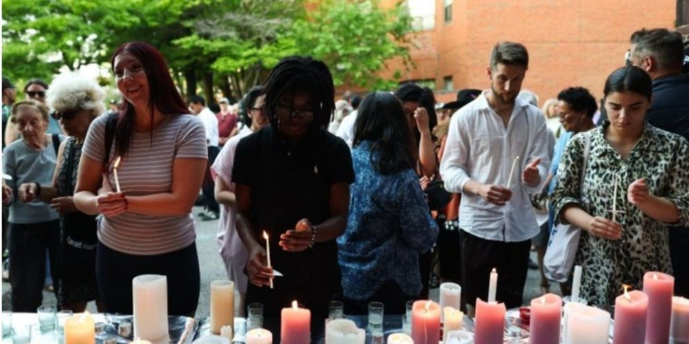 People attend a vigil following the deadly Salsa on St. Clair shooting in Toronto