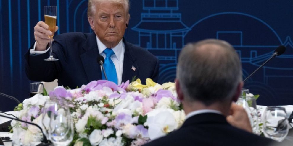 U.S. President Donald Trump and Prime Minister Mark Carney raise their glasses during a working dinner in South Korea.