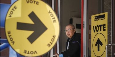 Voter leaves a polling station after casting a ballot during the 2025 federal election in Calgary.